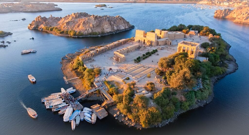 Boat approaching Philae Temple at sunrise